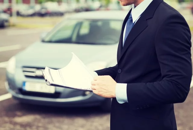 Insurance adjuster reading policy documents
