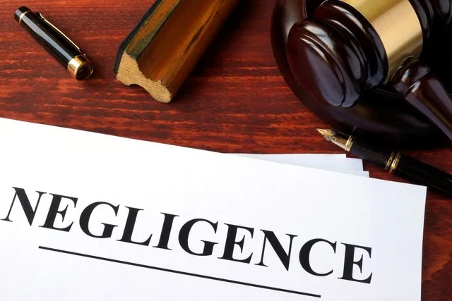 Negligence form, documents and gavel on a table